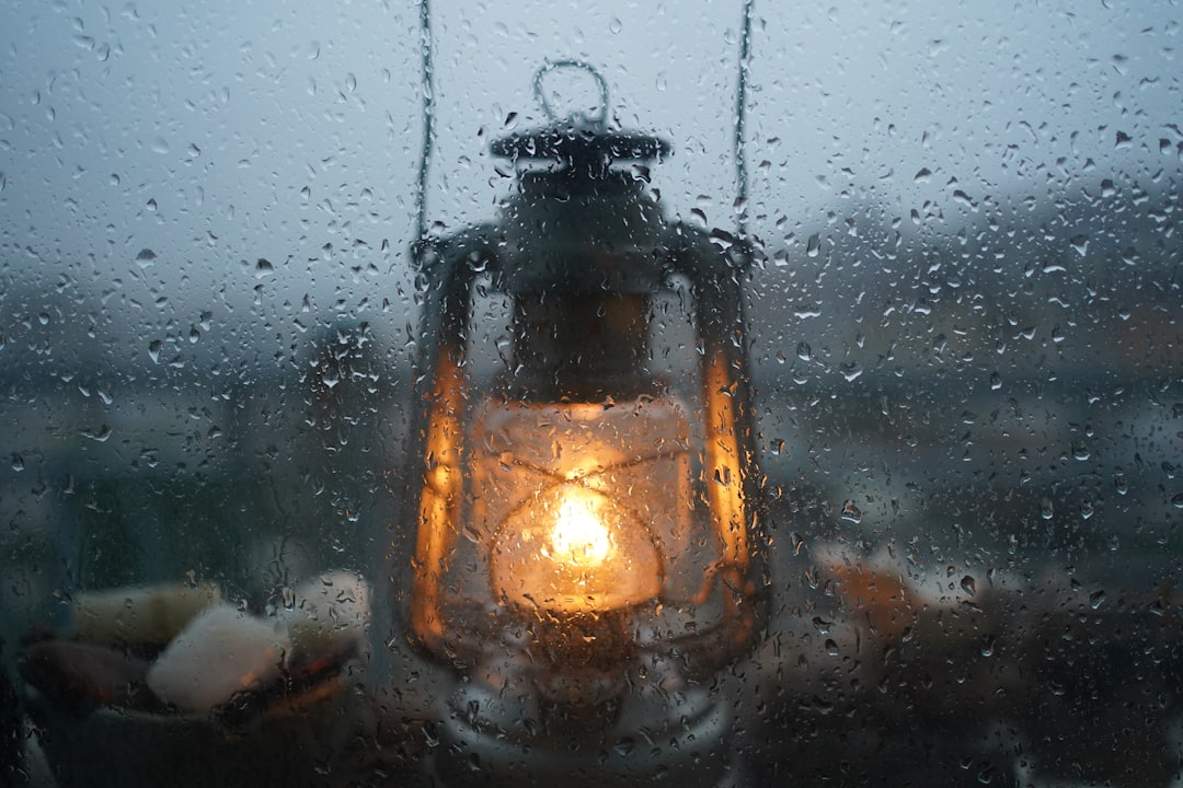 A beautifully lit campsite at dusk featuring a variety of Japanese-inspired lanterns casting warm li