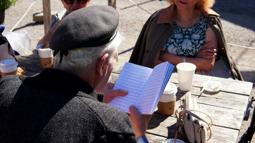 An image of the Pilot G2 pen in action, writing on a notebook filled with sketches and notes, giving