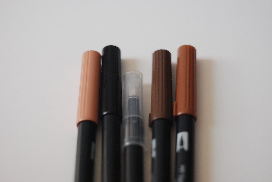 Image showing the Tombow Dual Brush Pen with colorful strokes on a watercolor paper background.