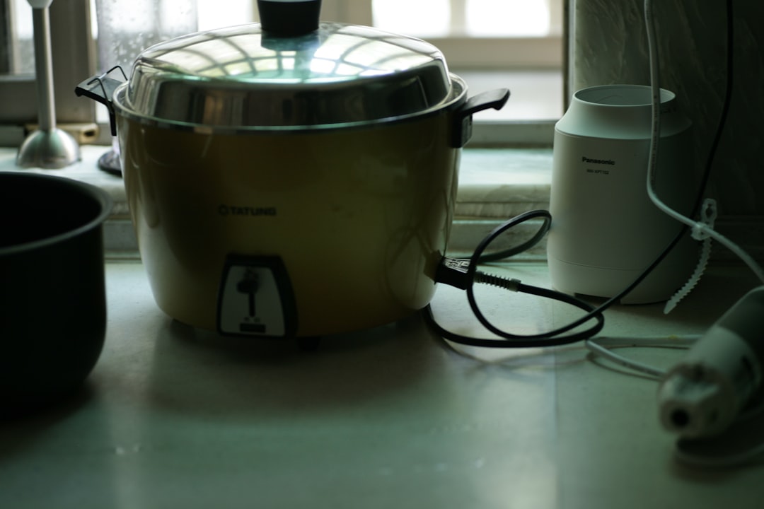 An elegant image featuring a Zojirushi and a Tiger rice cooker side by side, with a bowl of perfectl