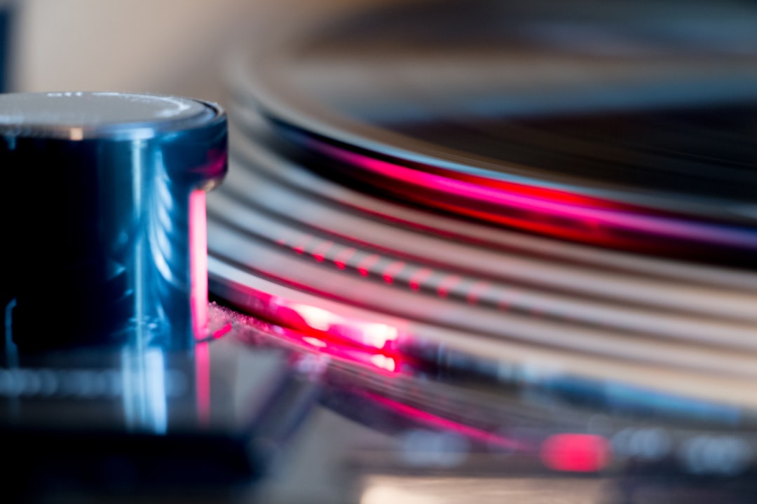 A sleek, modern turntable setup with vinyl records in the background, showcasing an Audio-Technica t