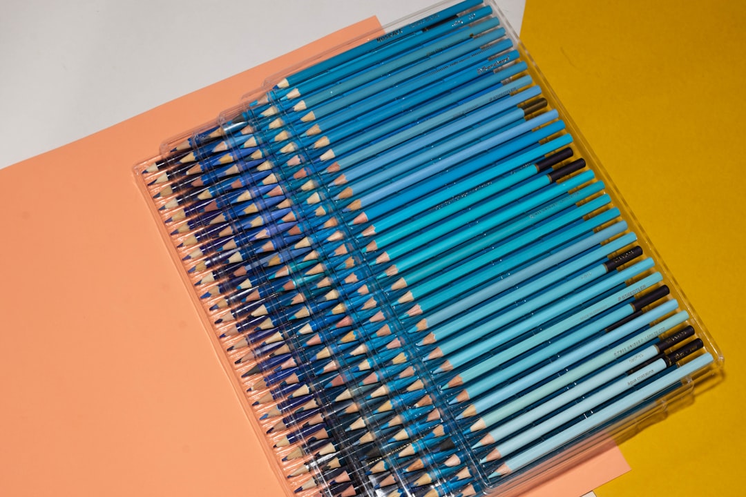 A vibrant flat lay of Pilot G2 and Zebra Sarasa gel pens in various colors, with swatches of their i