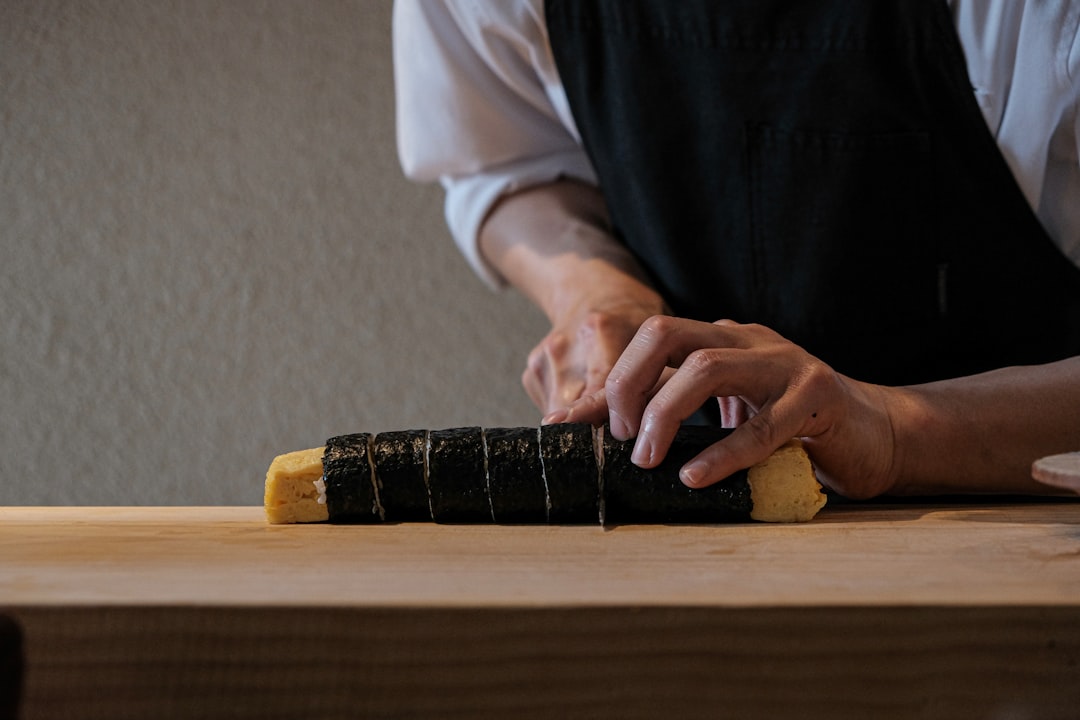 A beautifully arranged display of various Yoshihiro knives on a wooden surface, highlighting their u