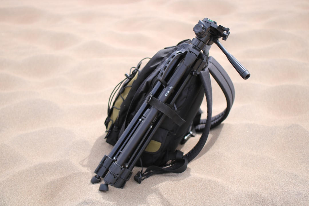 An image of a lightweight camera bag and accessories laid out on a hiking trail, emphasizing the imp