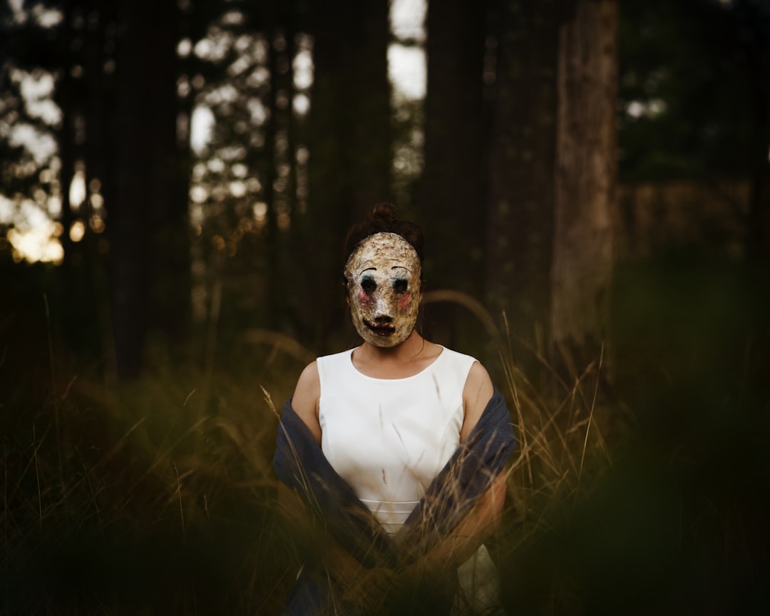 A serene outdoor scene featuring a person applying a sheet mask while enjoying nature, surrounded by
