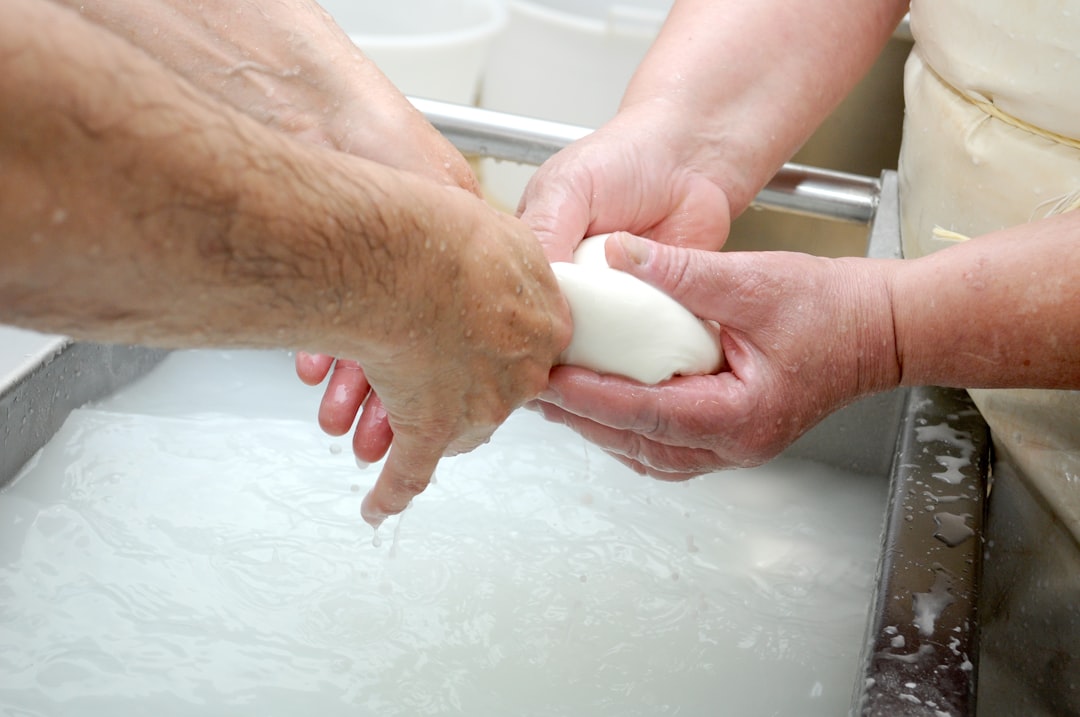 An image of the Hada Labo Gokujyun Foaming Cleanser being dispensed into a hand, with a foamy textur