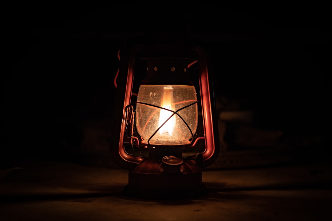 An image of a campsite at night with multiple lanterns creating a warm ambiance, illustrating the Ja