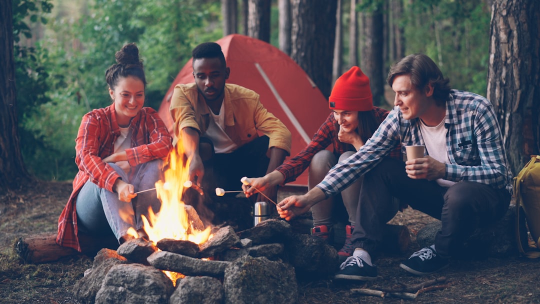 A lifestyle image of a camper preparing a meal using a multi-use pot that doubles as a frying pan, s