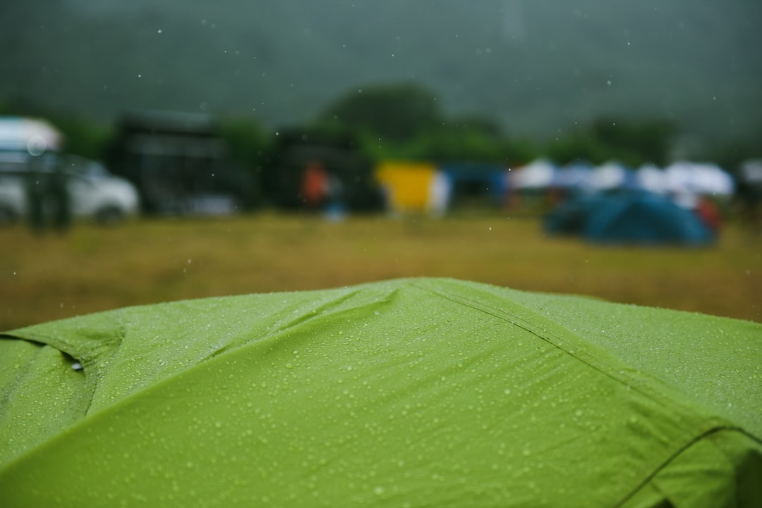 Image of the Montbell Rain Tarp set up in a rainstorm, showcasing its waterproof features and how it