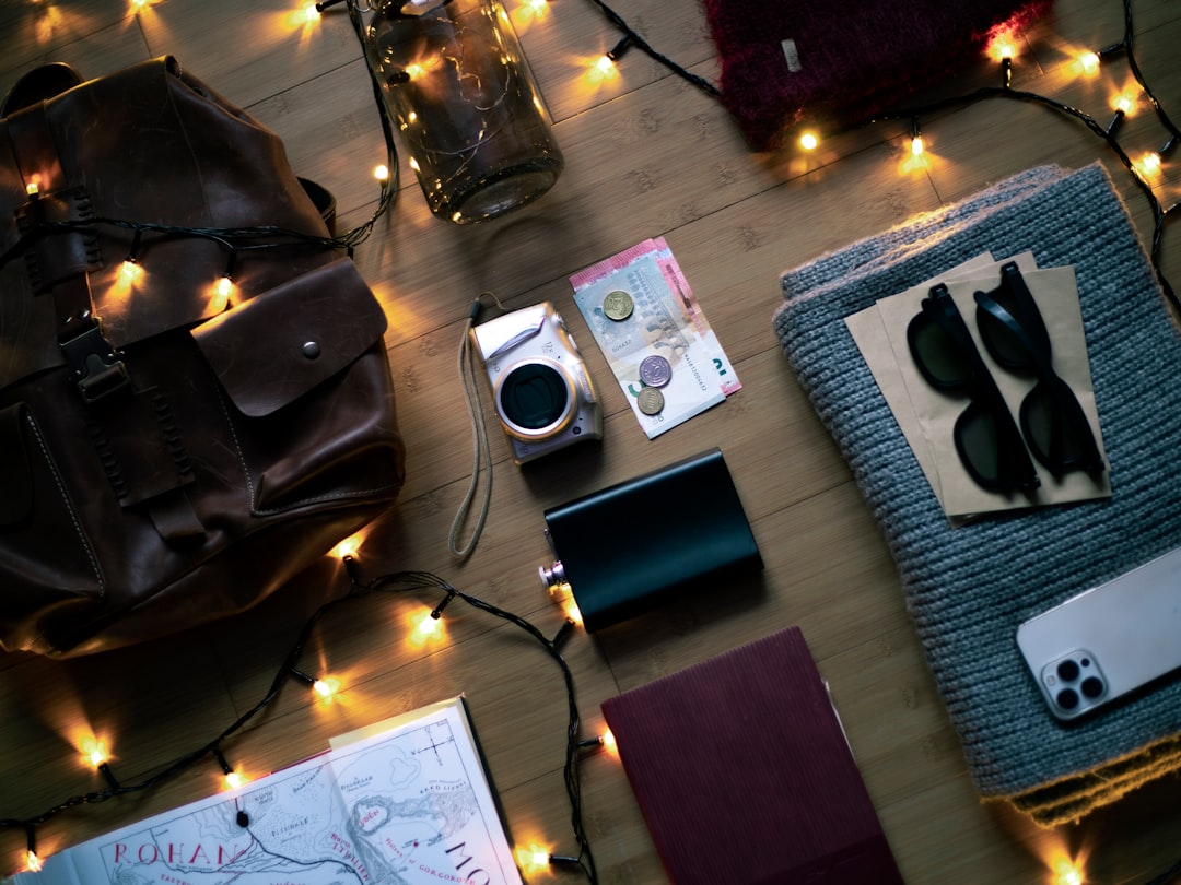 Close-up shot of the Olympus OM-D E-M10 Mark III camera on a travel-themed flat lay, with travel ess