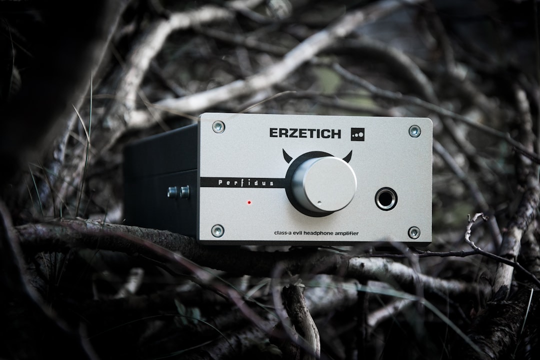 A scenic outdoor image showcasing a person wearing Sony noise-canceling headphones while relaxing in