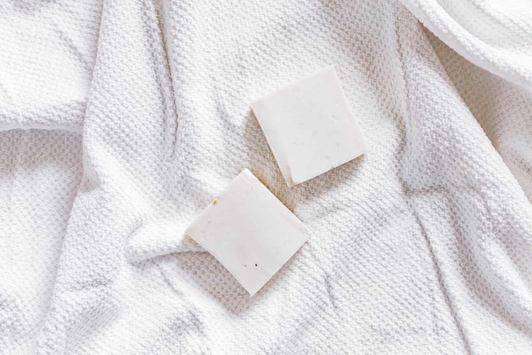 An image of Muji cotton pads displayed next to a skincare product, emphasizing their softness and qu
