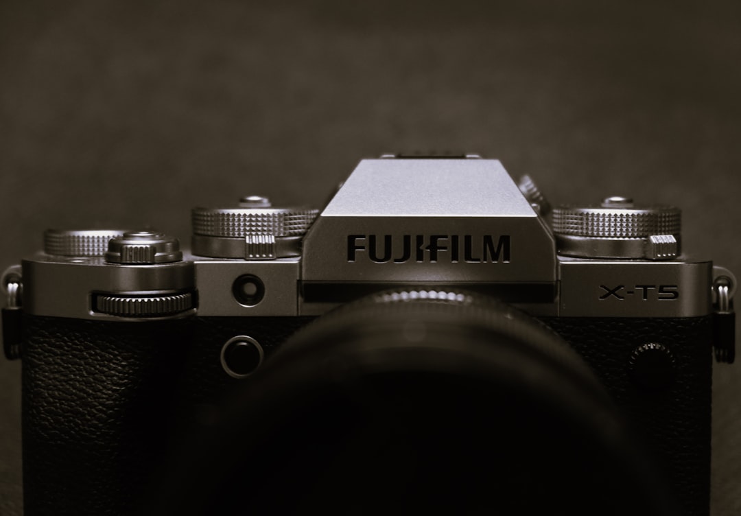 An action shot of a Fujifilm X-T4 being used in an outdoor setting, depicting a content creator capt
