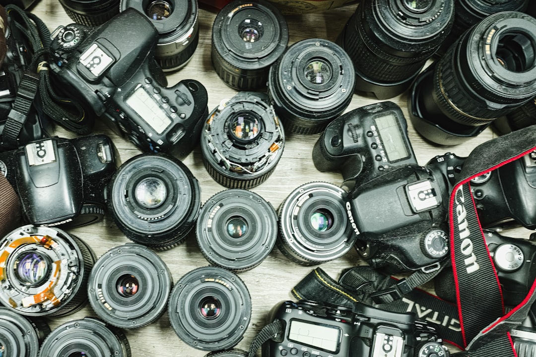 A dynamic shot featuring both an Olympus OM-D E-M1 Mark III and a Fujifilm X-T4 displayed on a styli