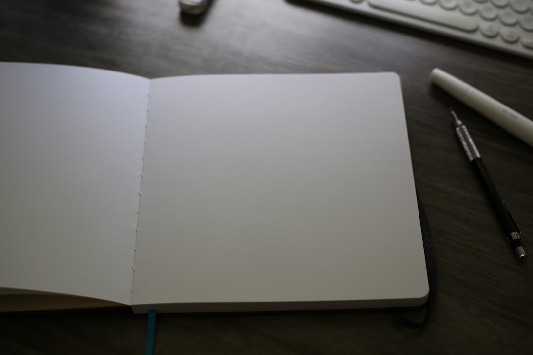 Image of a Muji A5 Notebook open on a desk with neatly written notes and minimalistic accessories ar