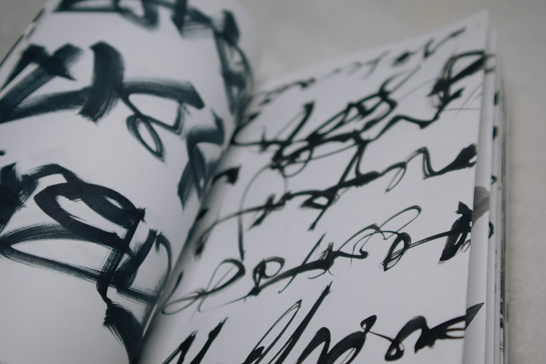 Artistic shot of the Zebra Zensations Brush Pen Highlighter being used for calligraphy, with strokes