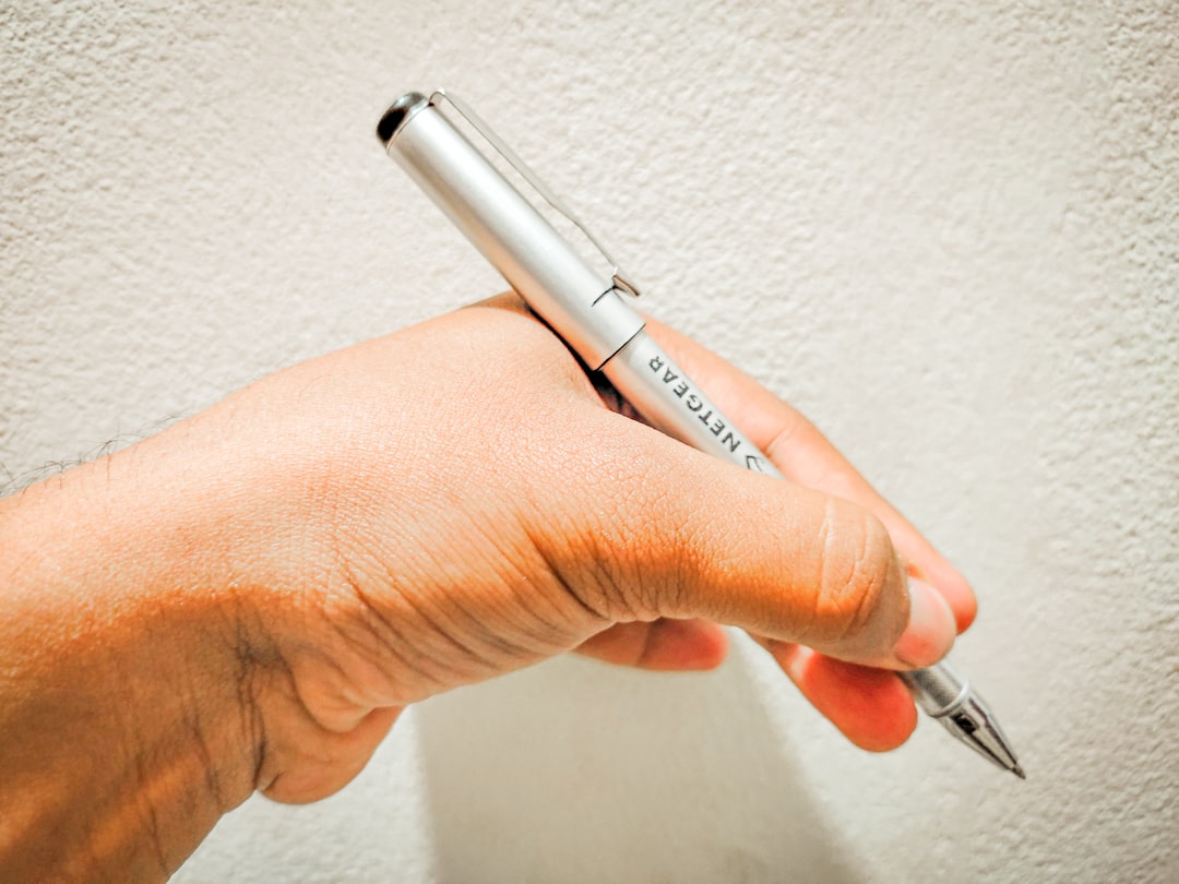 An image showcasing the Pilot Frixion Ball pen with a hand erasing ink on paper, highlighting its un