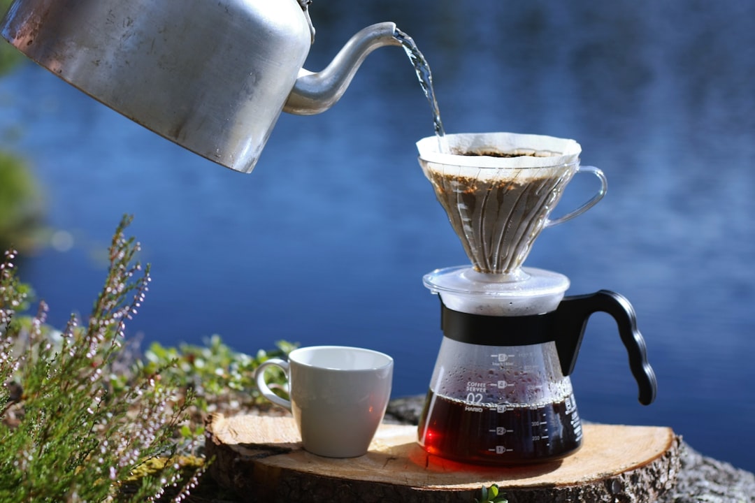 An image of the Hario V60 Dripper in use, with coffee being poured over it, highlighting the brewing