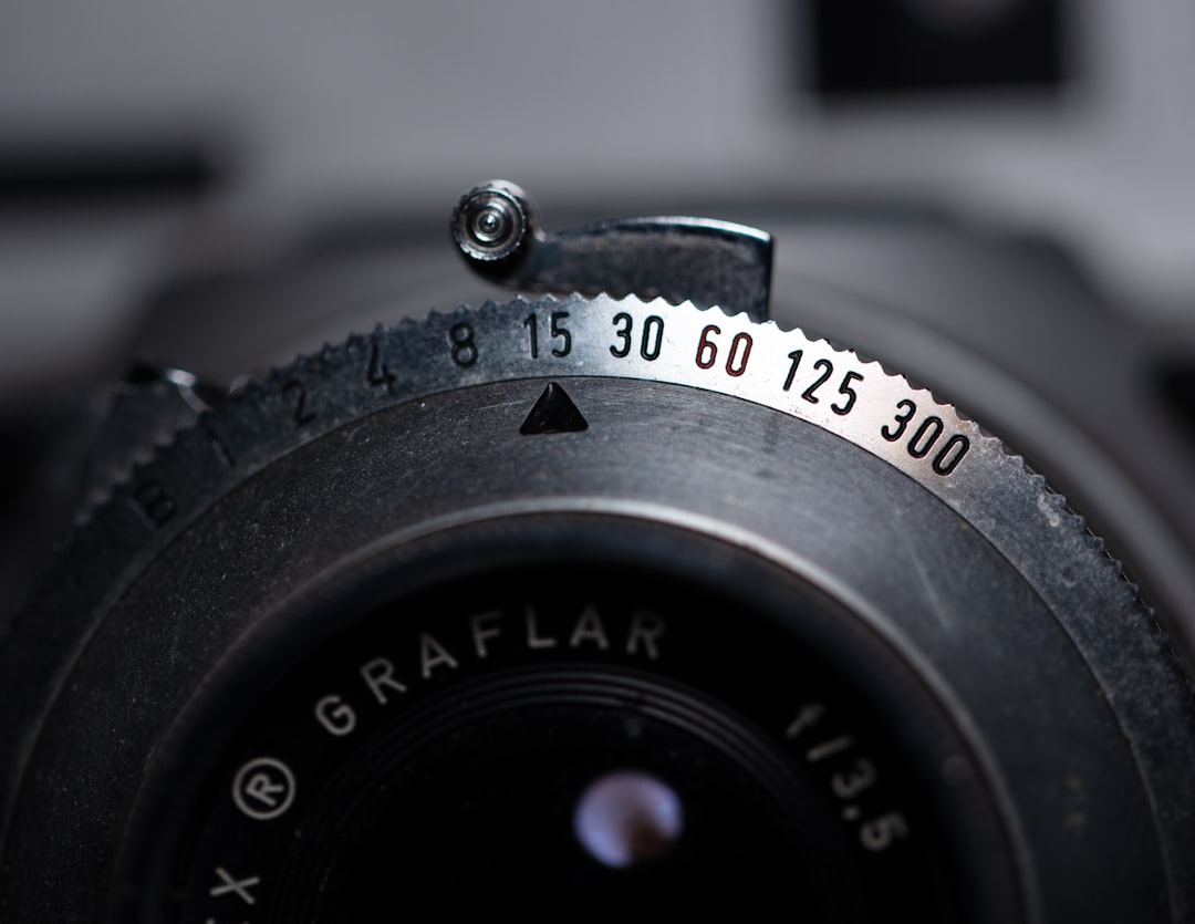 Close-up shot of the Olympus M.Zuiko Digital ED 12-40mm f/2.8 PRO Lens on a camera with a blurred ba