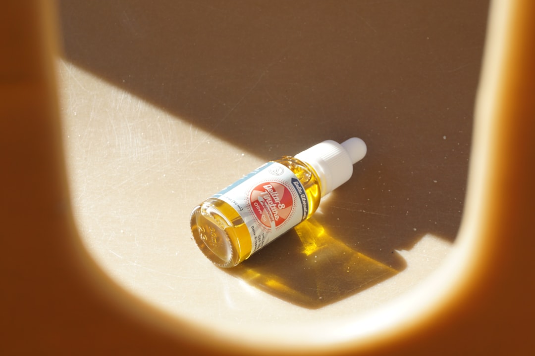 An image of MUJI Cleansing Oil bottle surrounded by natural elements, like olive branches or water d
