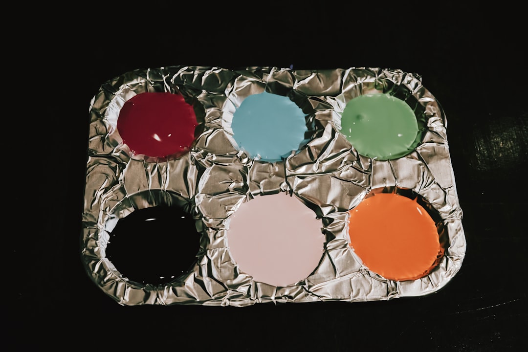 An image featuring the Kanebo Eye Color Palette open with swatches of the eyeshadow colors on a skin