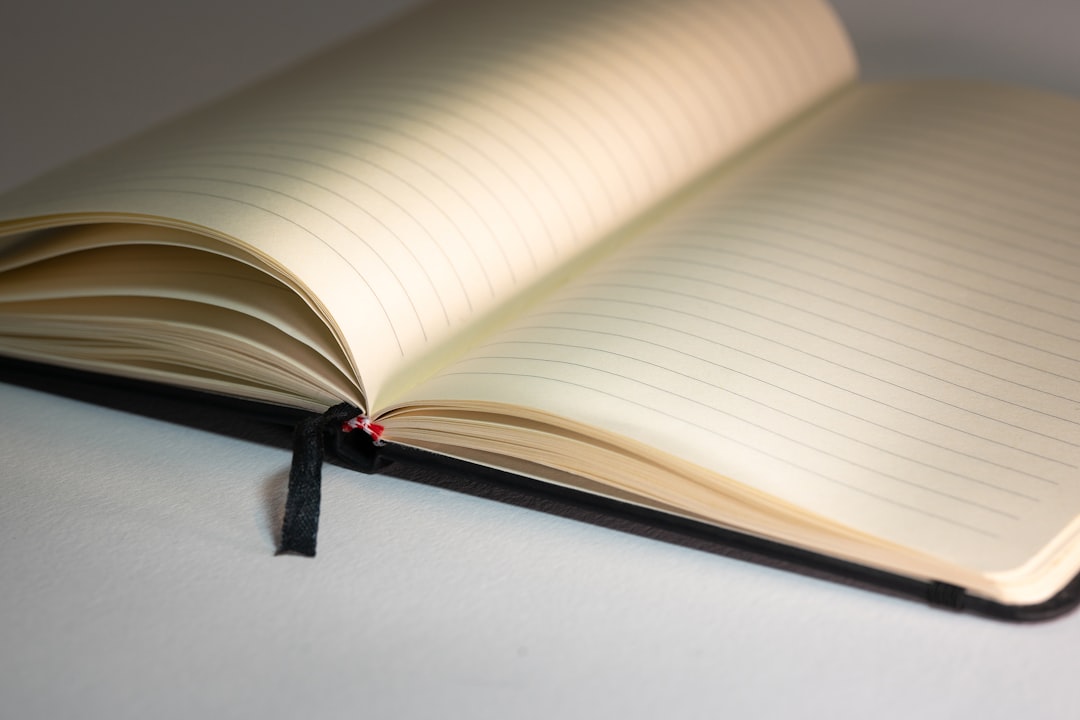 An image showing a Uni Mitsubishi notebook open with sketches and notes made on its pages, with natu