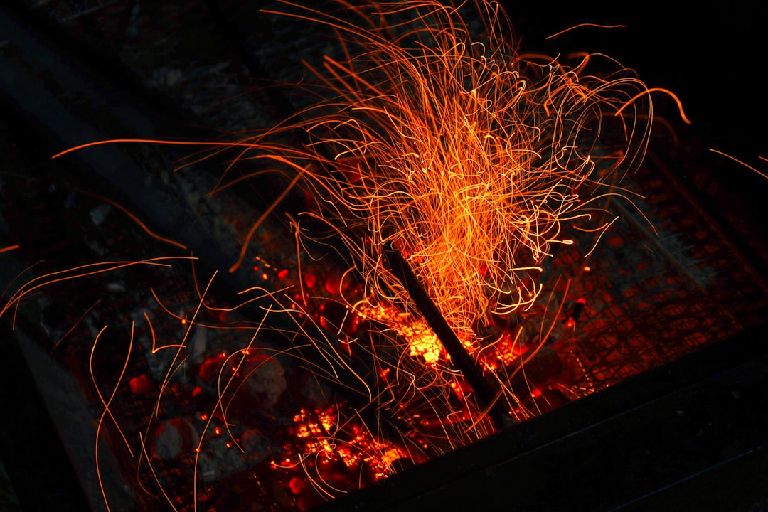 Close-up image of the Soto WindMaster Stove in action, with flames visible and a pot of food cooking