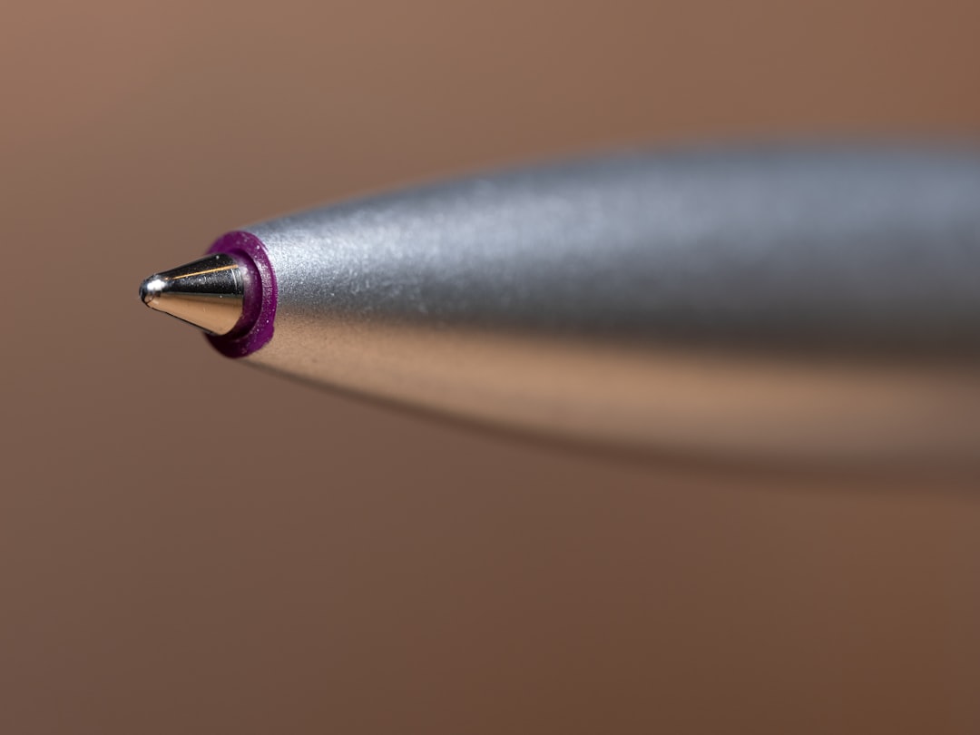 A close-up shot of the Pentel Graph Gear 1000 mechanical pencil, highlighting its retractable tip an