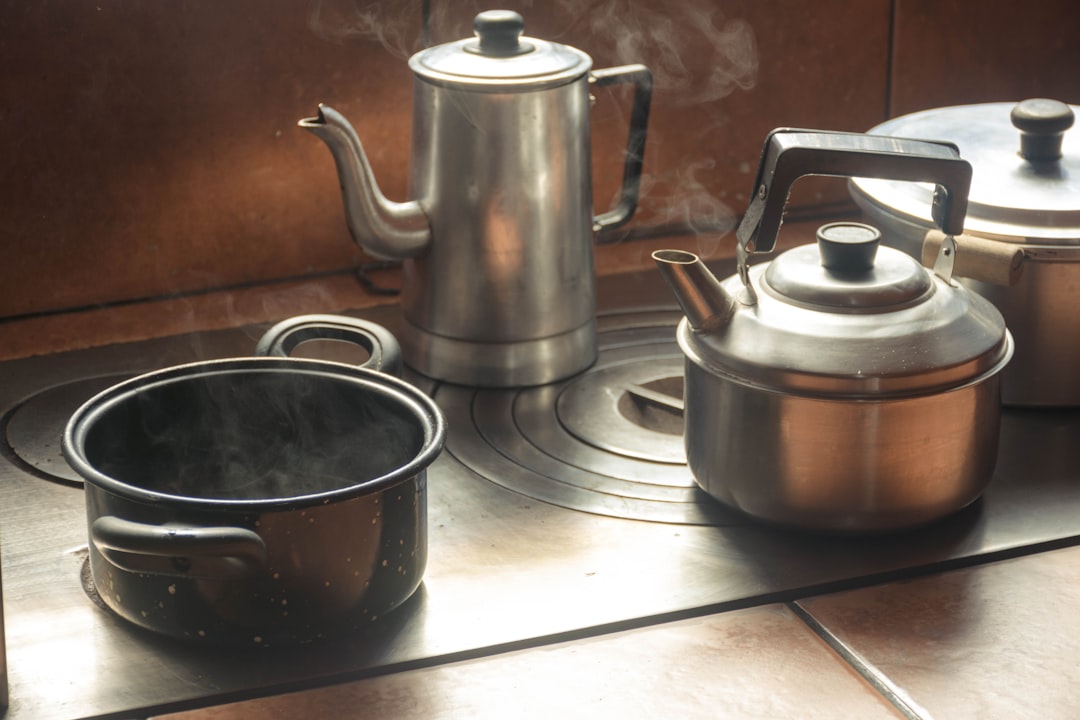 A modern kitchen setting featuring the Zojirushi Stainless Steel Kettle in use, with tea brewing in