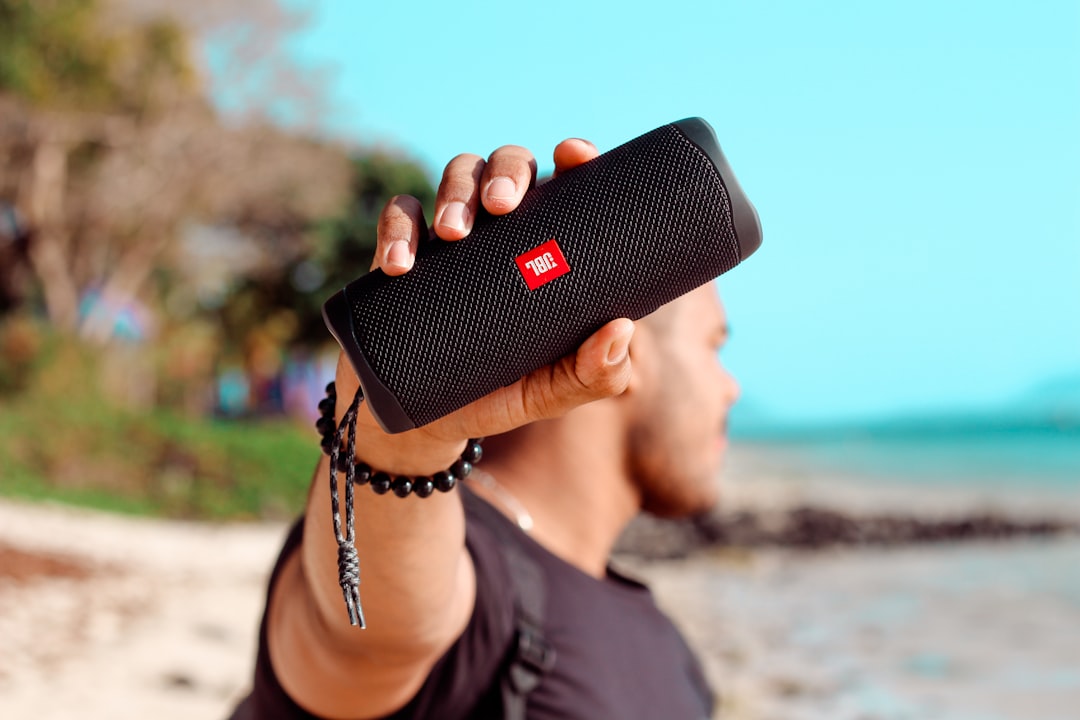 A lively image of the Sony SRS-XB43 Portable Bluetooth Speaker on a beach picnic setup, with friends