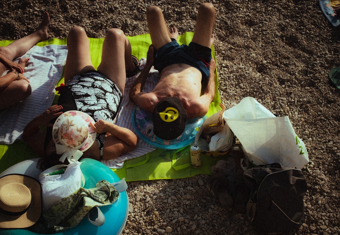 Lifestyle shot of a diverse group of friends applying sunscreen during a camping trip, showcasing va