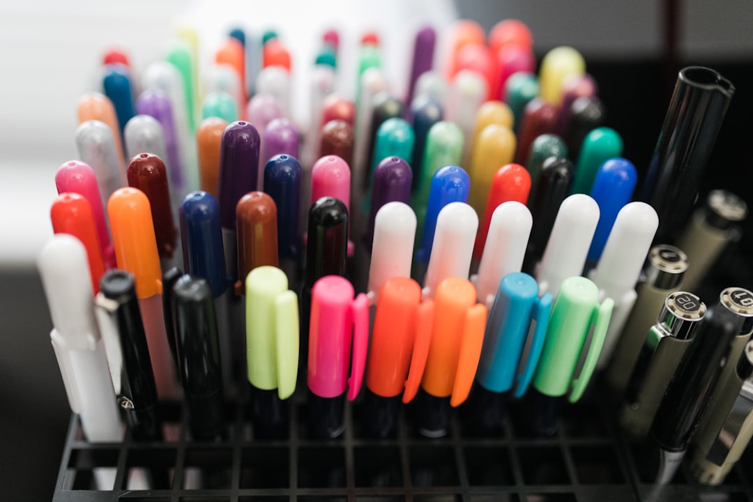 A vibrant flat lay image featuring an array of Pilot and Zebra gel pens in various colors, alongside