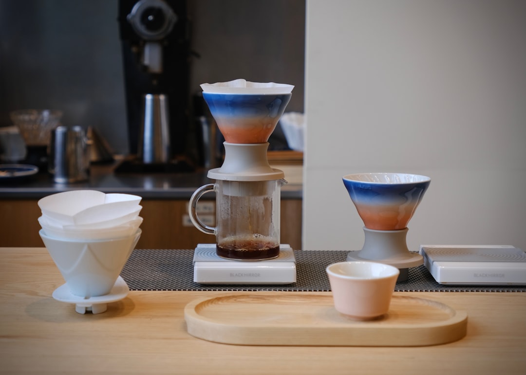 A comparison image showing both the Hario V60 and Kalita Wave side by side, with labeled features po