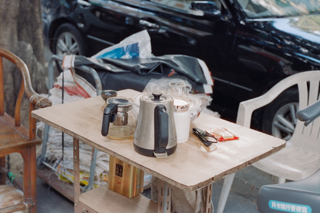 A beautifully styled image of both Hario and Zojirushi kettles set in a serene outdoor environment,