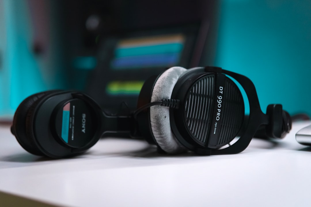 An image of the Sony MDR-7506 headphones displayed on a table with an audio interface and microphone