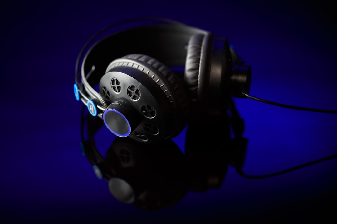 A dynamic shot of Audio-Technica ATH-M50x headphones in use, worn by a musician mixing tracks at a h