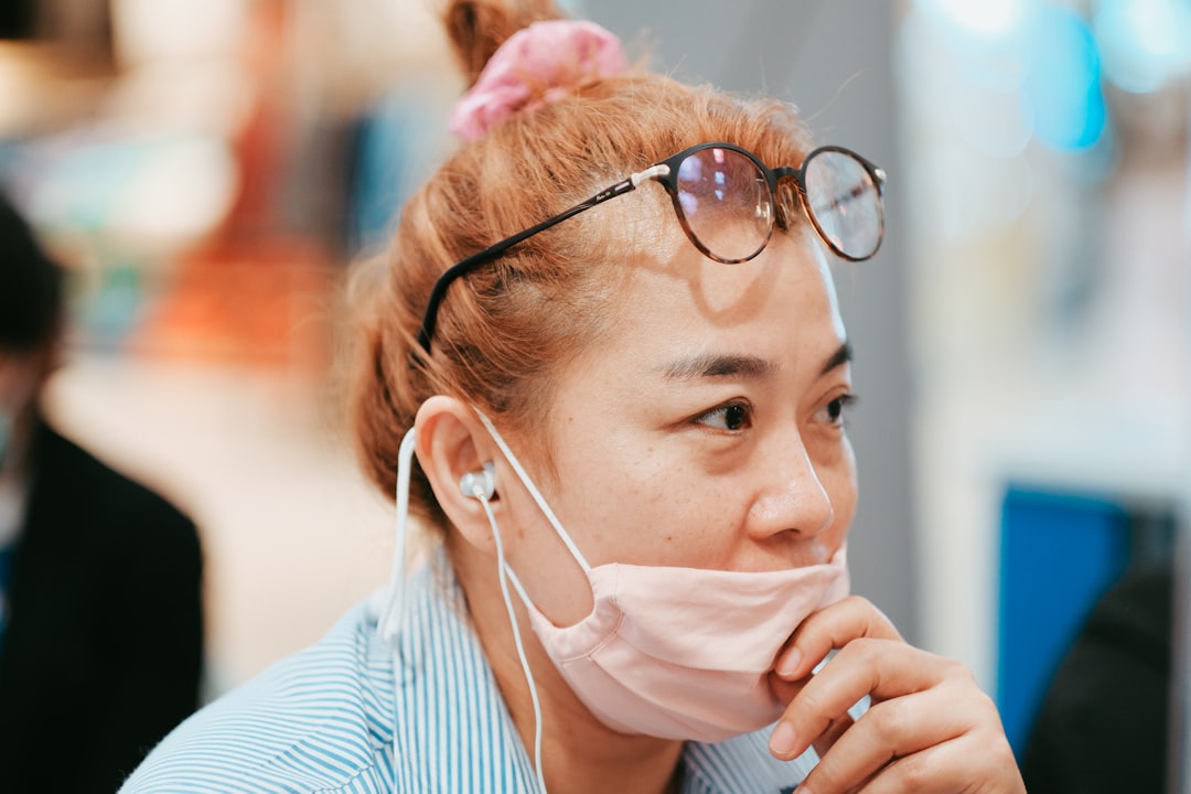 An image of a person using the Sony WH-1000XM4 headphones while traveling in an airport, capturing t