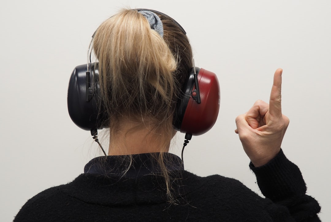An image of a person adjusting the noise cancellation levels on the Bose 700 headphones, showcasing 