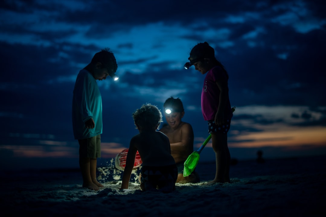 A lifestyle shot of the Uniflame LED Lantern being used by a family at a campsite, providing illumin