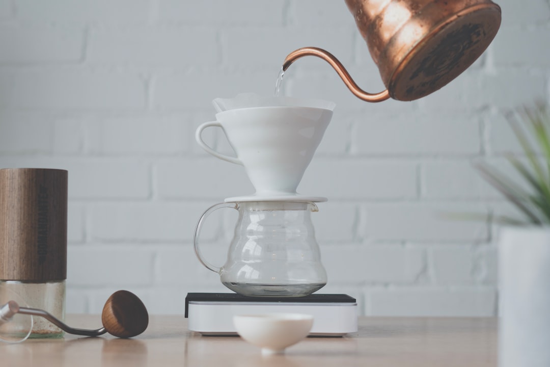 Close-up image of the Hario V60 Dripper in use, highlighting its ceramic material and minimalist des