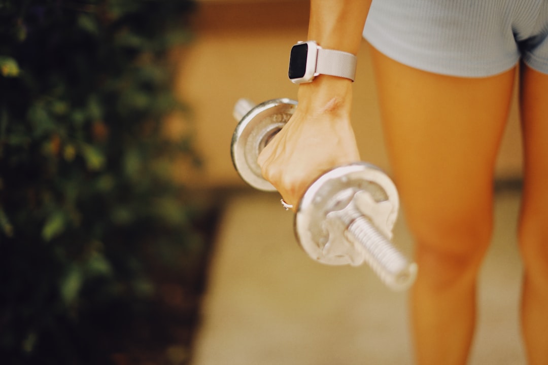 An active shot of a person using the Sony SmartWatch 4 while jogging in a park, highlighting its hea