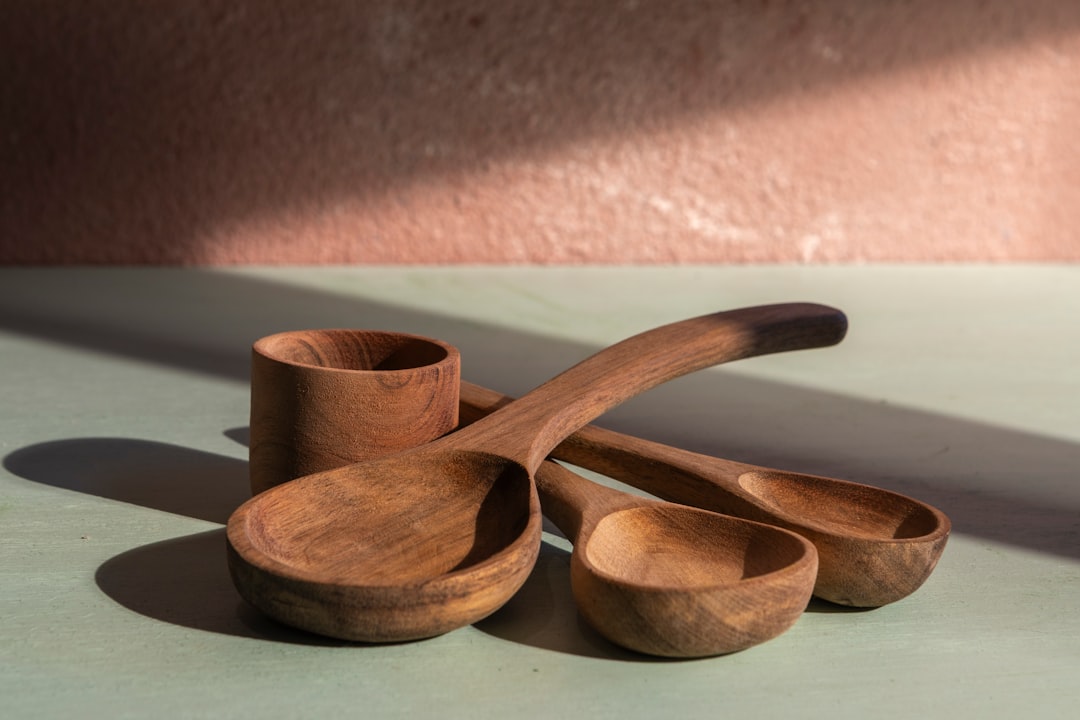 A beautifully styled image of an array of Tiger cast iron cookware displayed on a rustic wooden kitc