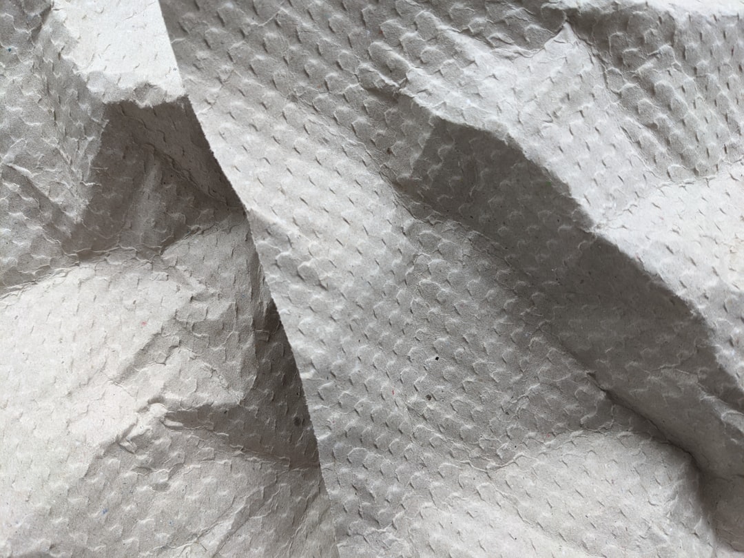 A vibrant, close-up shot of Hada Labo and SK-II sheet masks side by side, with droplets of water or