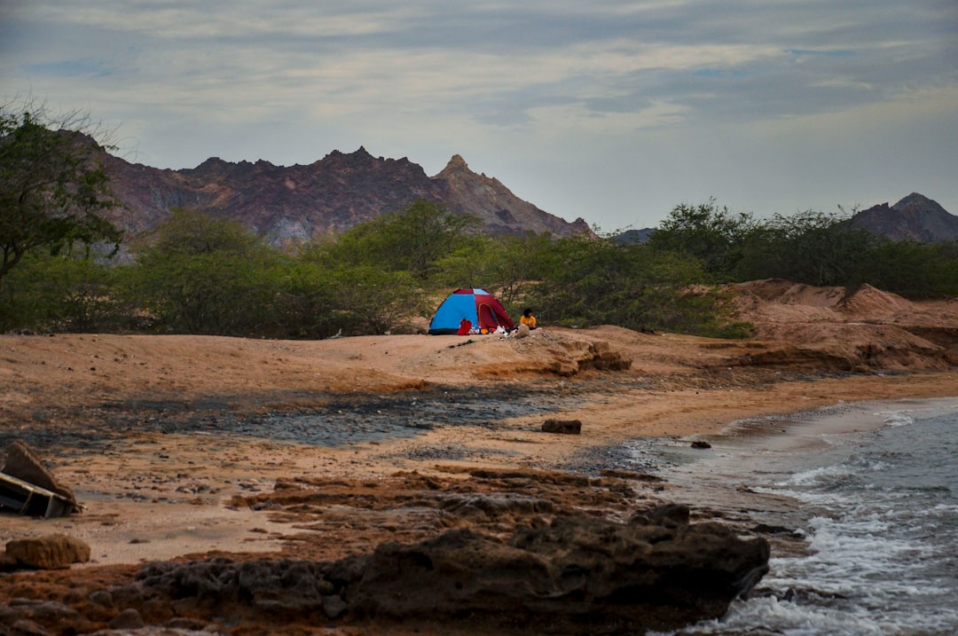 Image of the Snow Peak Land Lock 4 tent set up in a family camping scenario, showing the spacious in