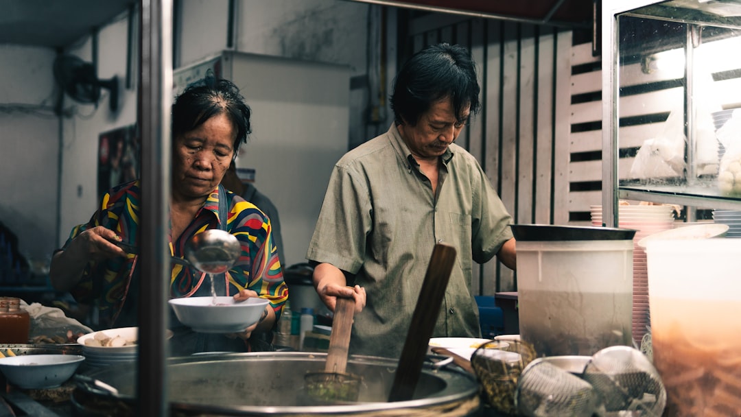 Lifestyle image showing a busy family in an American kitchen using a Tiger JNP-S10U-HU basic rice co