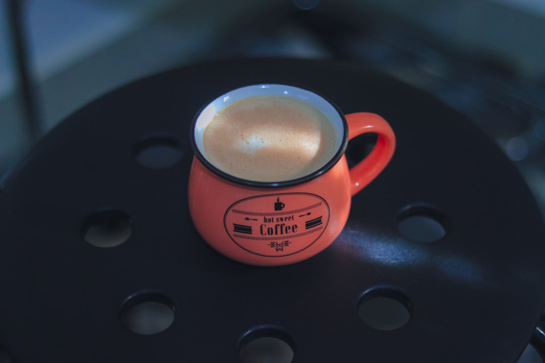 Close-up image of the Hario V60 Ceramic Coffee Dripper on top of a standard camping mug with freshly