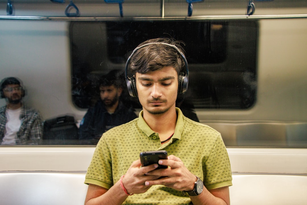 Lifestyle image of a commuter wearing Audio-Technica ATH-SR30BT wireless headphones on a city street