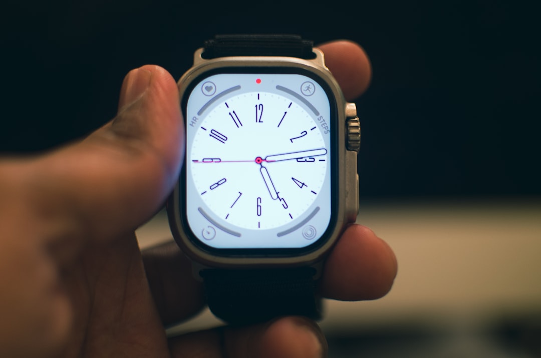 A sleek Panasonic smartwatch worn on a wrist, shown in a clean, modern environment that blends techn