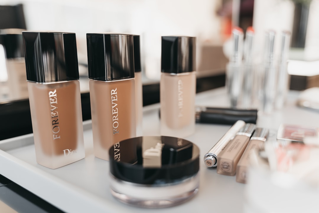 Close-up product flat lay featuring Kanebo Sensai Foundation Fluid and Kanebo Impress Foundation bot