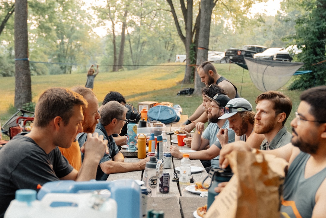 Image showing the Captain Stag Steel Folding Table (M-3105) in use during a larger family camping me